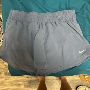 Nike running shorts, more of like a blue than a grey